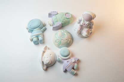 Paint Your Own Plaster Space Bumper Pack painted in soft blue lilac and pink
