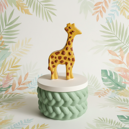 Painted golden yellow giraffe trinket box with sage green base on gentle jungle background