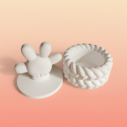 White plaster cartoon hand trinket box lid off showing inside storage on warm peach background