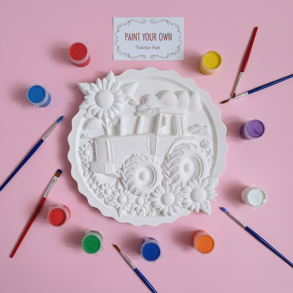 White tractor plaster plaque on pink background with paints