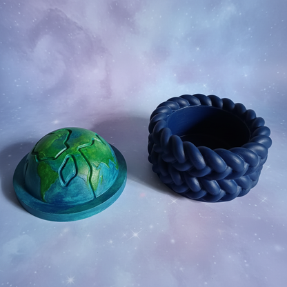 Painted half-globe trinket box lid off showing inside on lilac starry space background