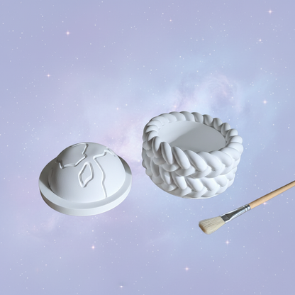 White plaster half-globe trinket box with paintbrush on soft lilac starry space background