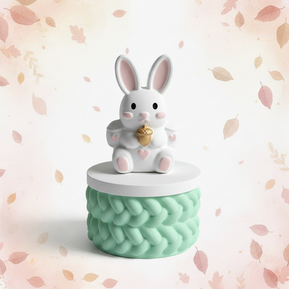 Painted white bunny rabbit trinket box with mint base on soft pastel autumn background