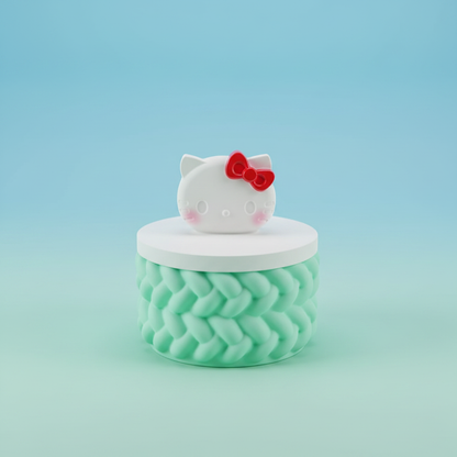 Painted cartoon cat face trinket box with red bow and mint green base on mint and baby blue background